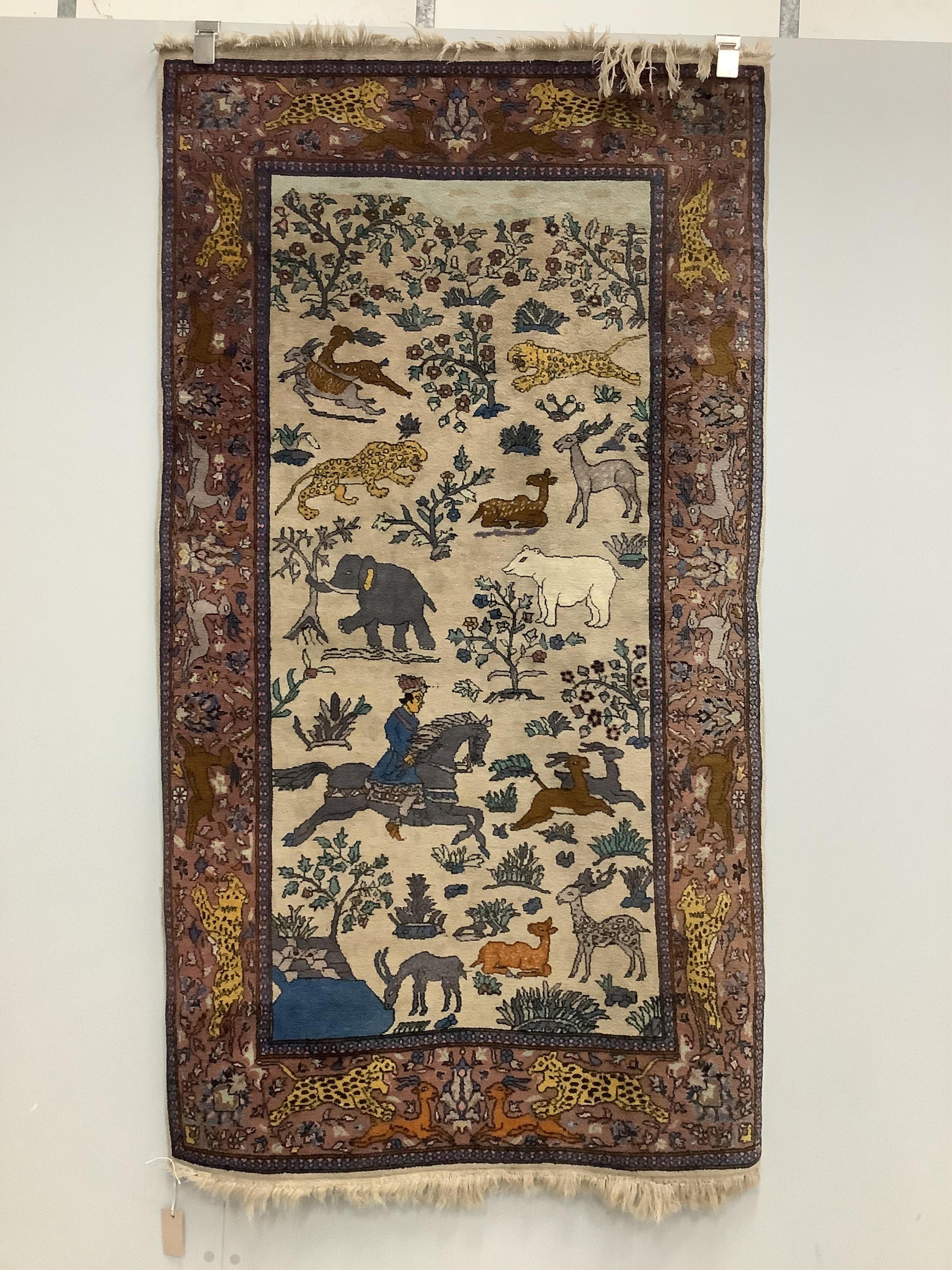 A modern North West Persian ivory ground rug, woven with a hunting scene, 170 x 95cm. Condition - fair